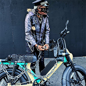 A masked bicyclist photographed in downtown LA